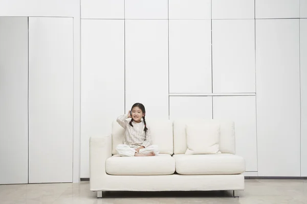 Girl sitting cross-legged Sofa