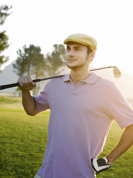 Golfer on course with club