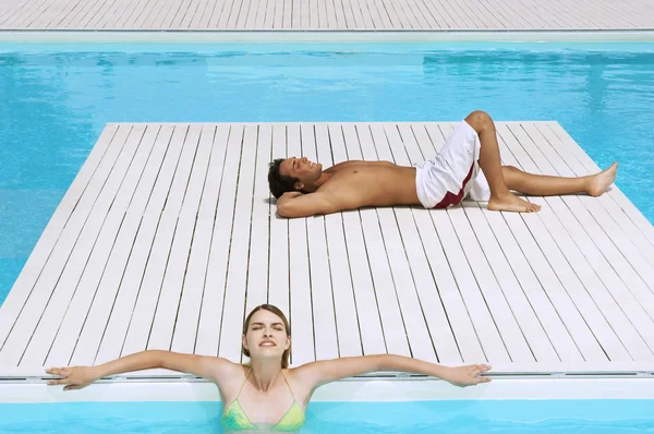 Couple Relaxing at Swimming Pool