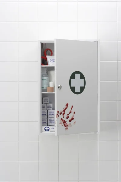 Blood hand print on medical cabinet