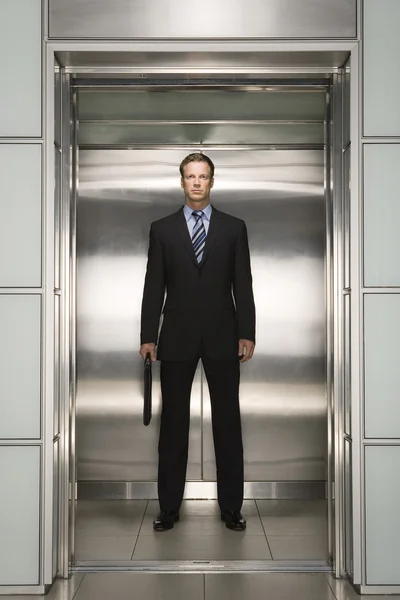 Businessman standing in Elevator