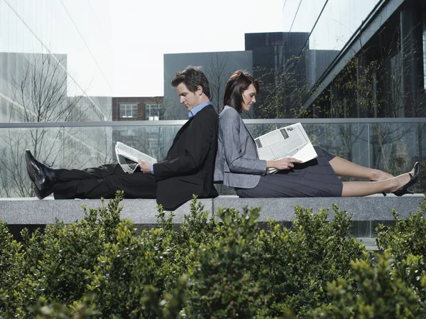 Business man and woman sitting
