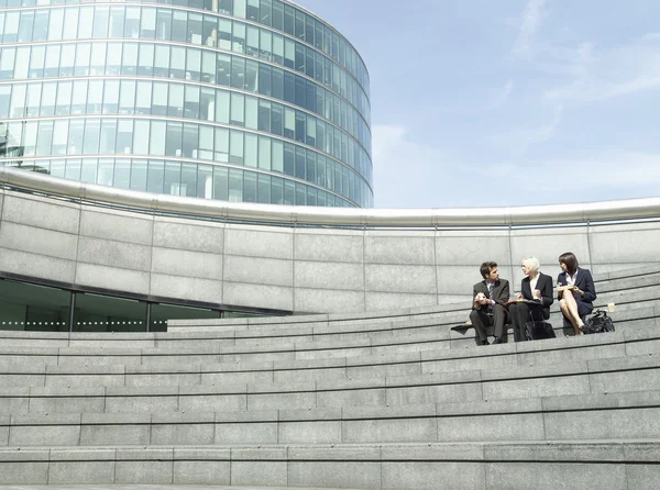 Business people sitting on stairs