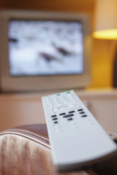 Remote control lying on armchair