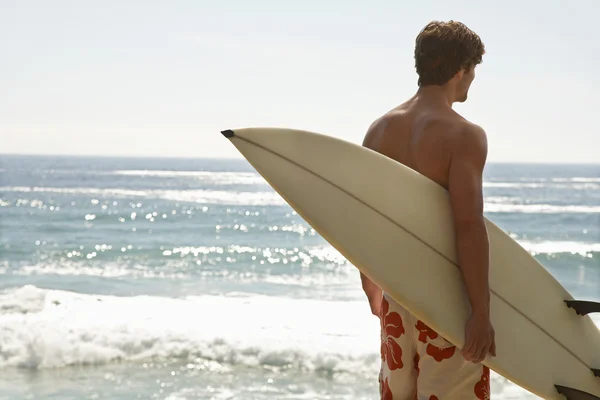 Man holding surfboard