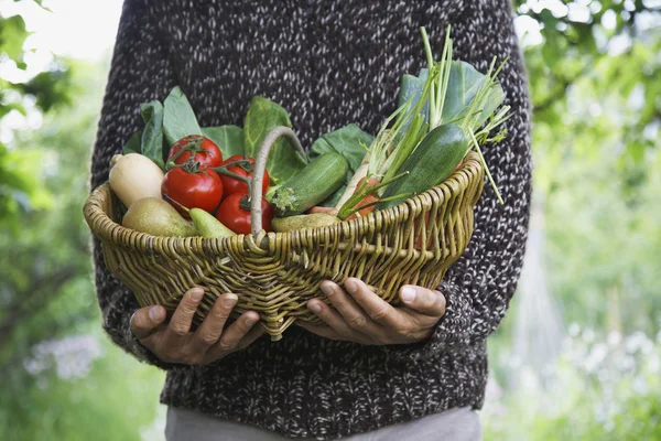 Man holding fruit and vegetable basket