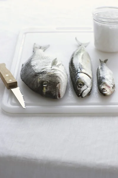 Fishes on chopping board