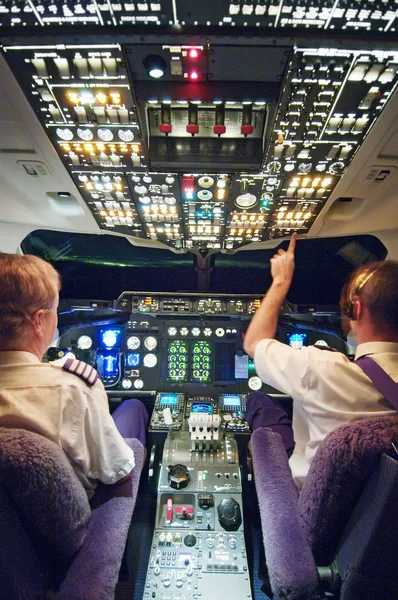 Pilots in aeroplane cockpit