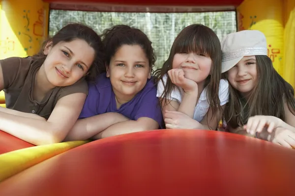 Girls lying in row in bouncy castle