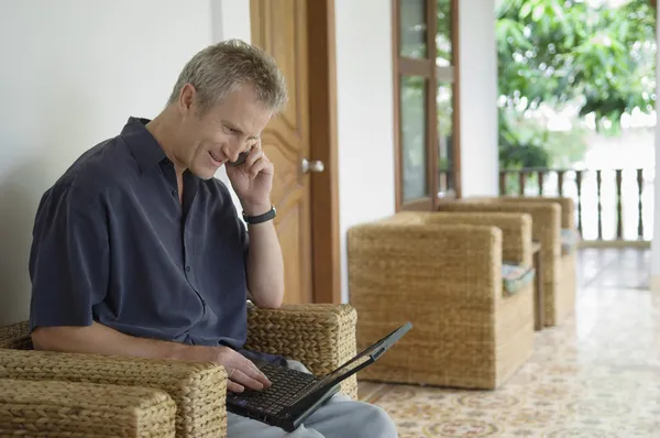 Man with Phone and Laptop