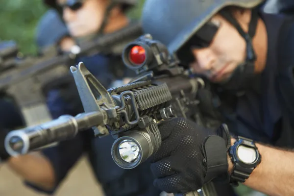 Swat officers aiming guns