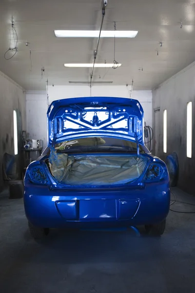 Blue painted car in garage