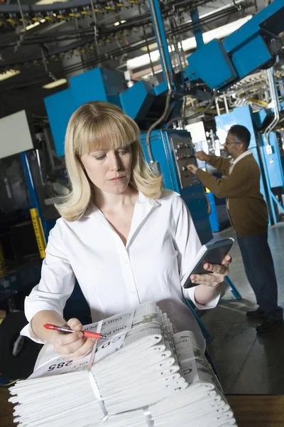 Female worker with calculator