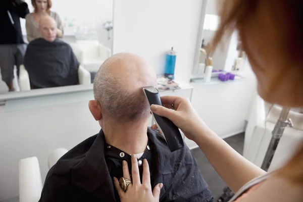 Man getting head shaved