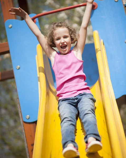 Girl on slide in playground