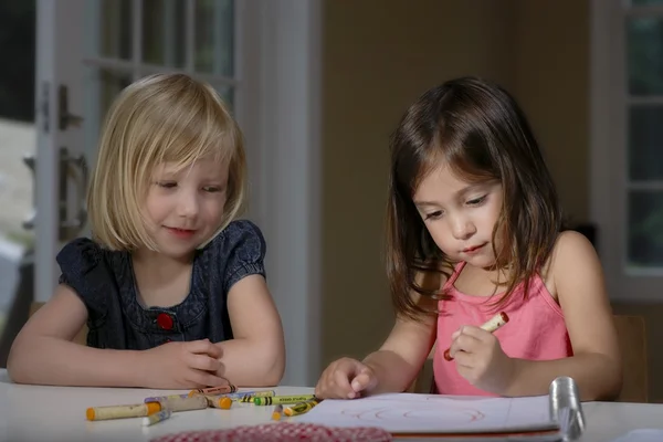 Girls drawing with crayons