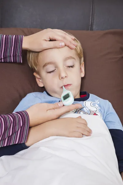 Mother checking boy\'s temperature