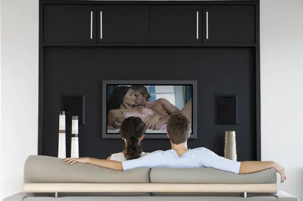 Couple watching  movie on television