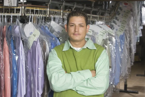 Man standing infront of clothes rail