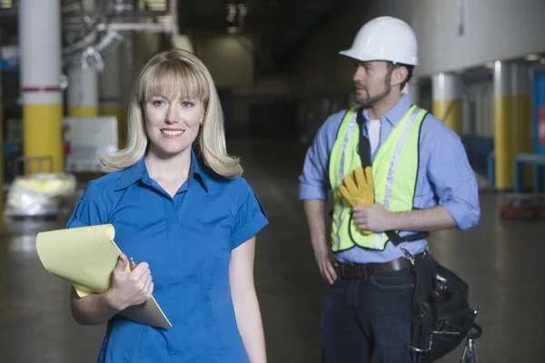 Man and woman working in newspaper factory