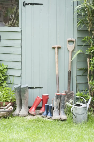 Garden tools and wellington boots