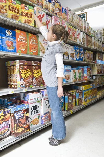 Girl reaching for cereal product