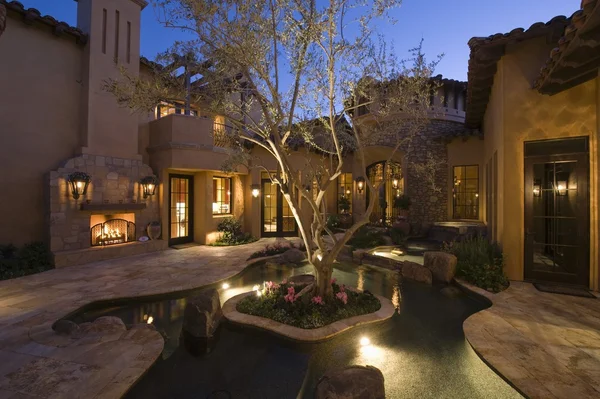 Lit Palm Springs courtyard with pool