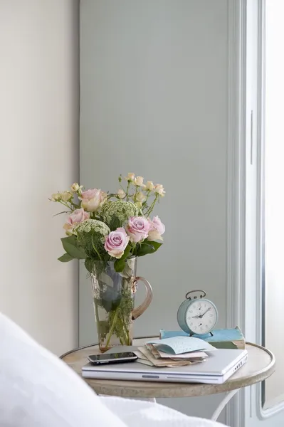 Roses in vase  with books