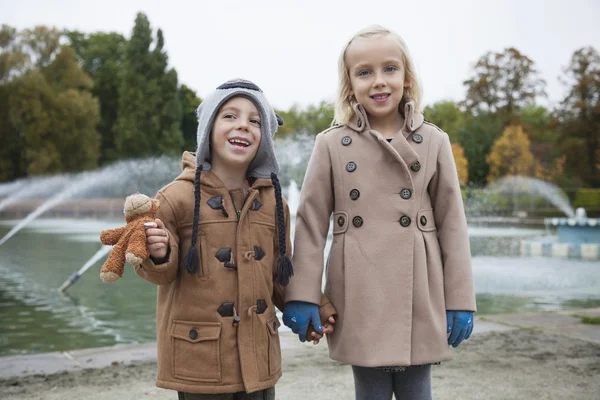 Brother and sister in trench coats