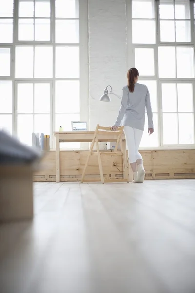 Woman walks across apartment