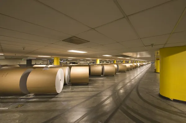 Huge rolls of paper in newspaper factory