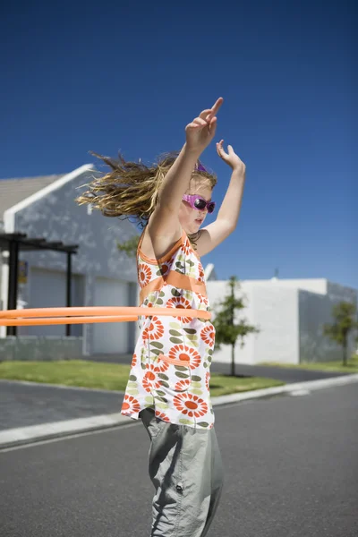 Girl playing with plastic hoop