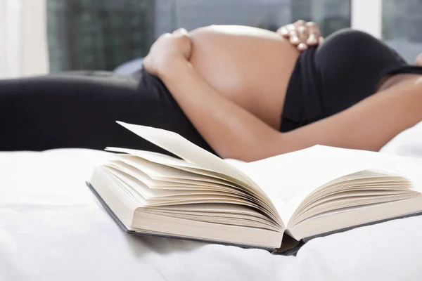 Pregnant woman lying in bed