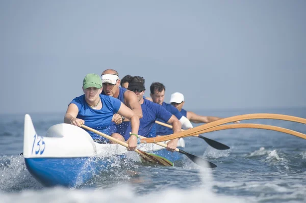 Outrigger canoeing team on water