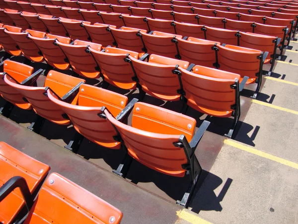 Rows of empty orange stadium seats