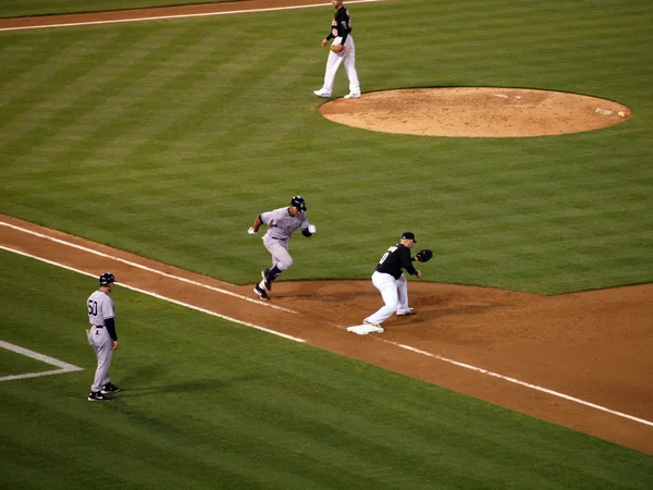 Yankee Alex Rodriguez runs to first base as Oakland A\'s first ba