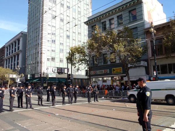 Police officers stand in line across market street at the six st