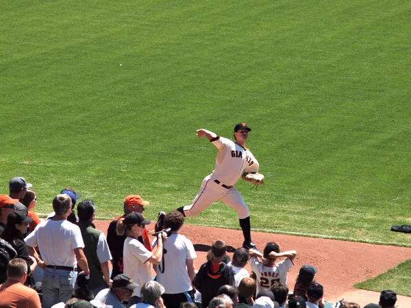 Giants Pitch Matt Cain steps forward with arm reaching back to t