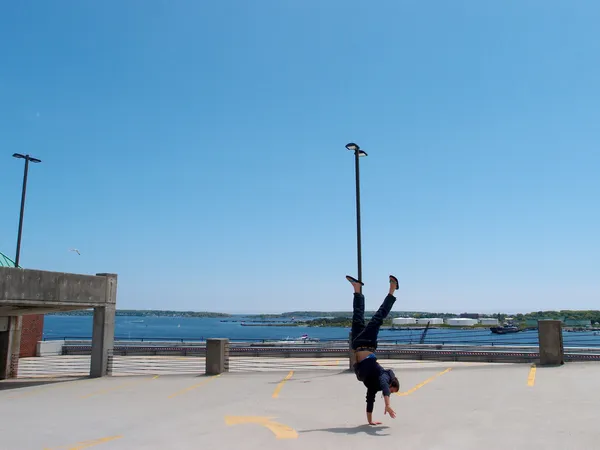 Man Handstands on top of a parking garage the City of Portland M