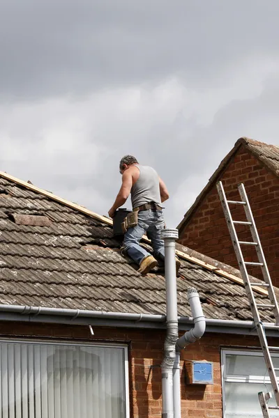 Workman repairing a roof