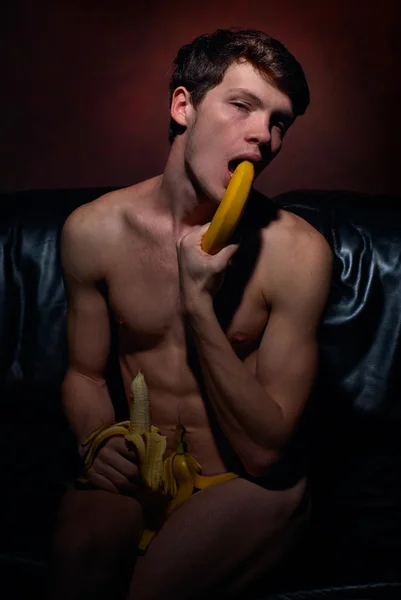 Homosexual man posing with banana
