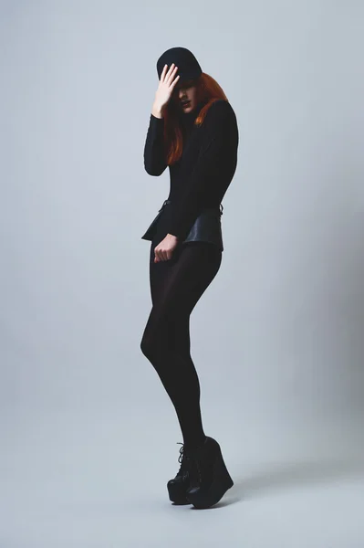 Red haired horsewoman on high heels