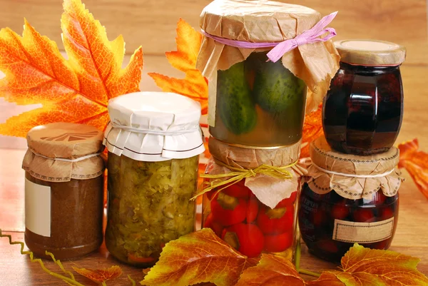 Jars of homemade preserves in autumn scenery