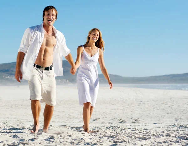 Carefree walking beach couple