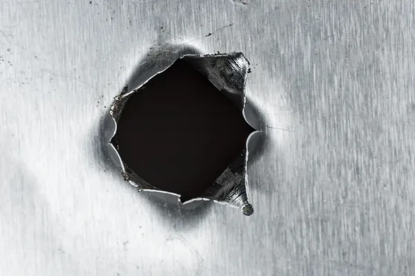 Bullet hole in sheet metal
