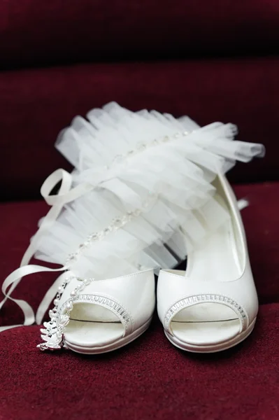 Two white bride weddings easy shoes on a dark background
