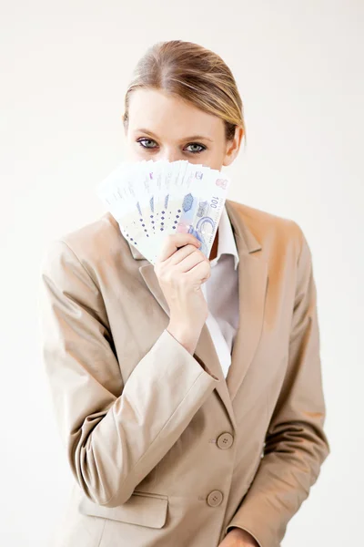 Young south african woman holding cash note close to her face
