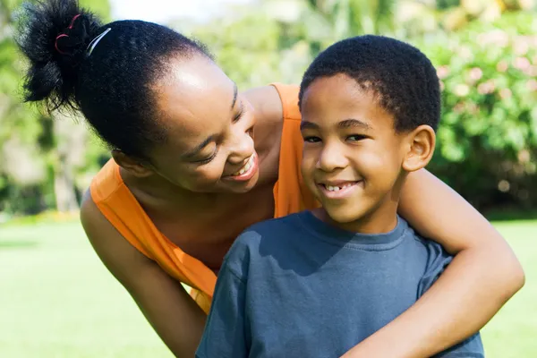 Happy african american mother and son outdoors