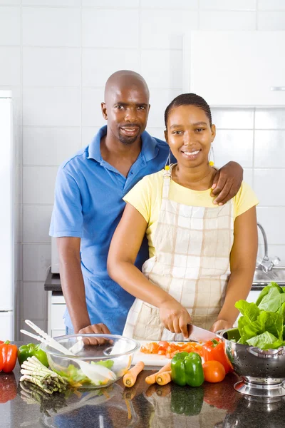 African american couple cooking in kitchen