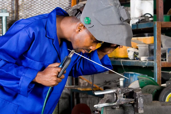 African american welder working in workshop